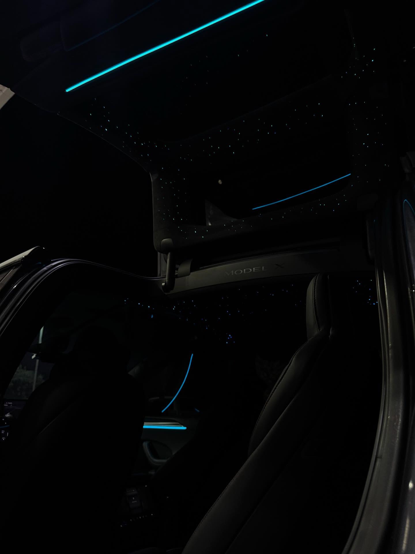 Tesla interior with starlight headliner and blue ambient lighting by WrapUp305